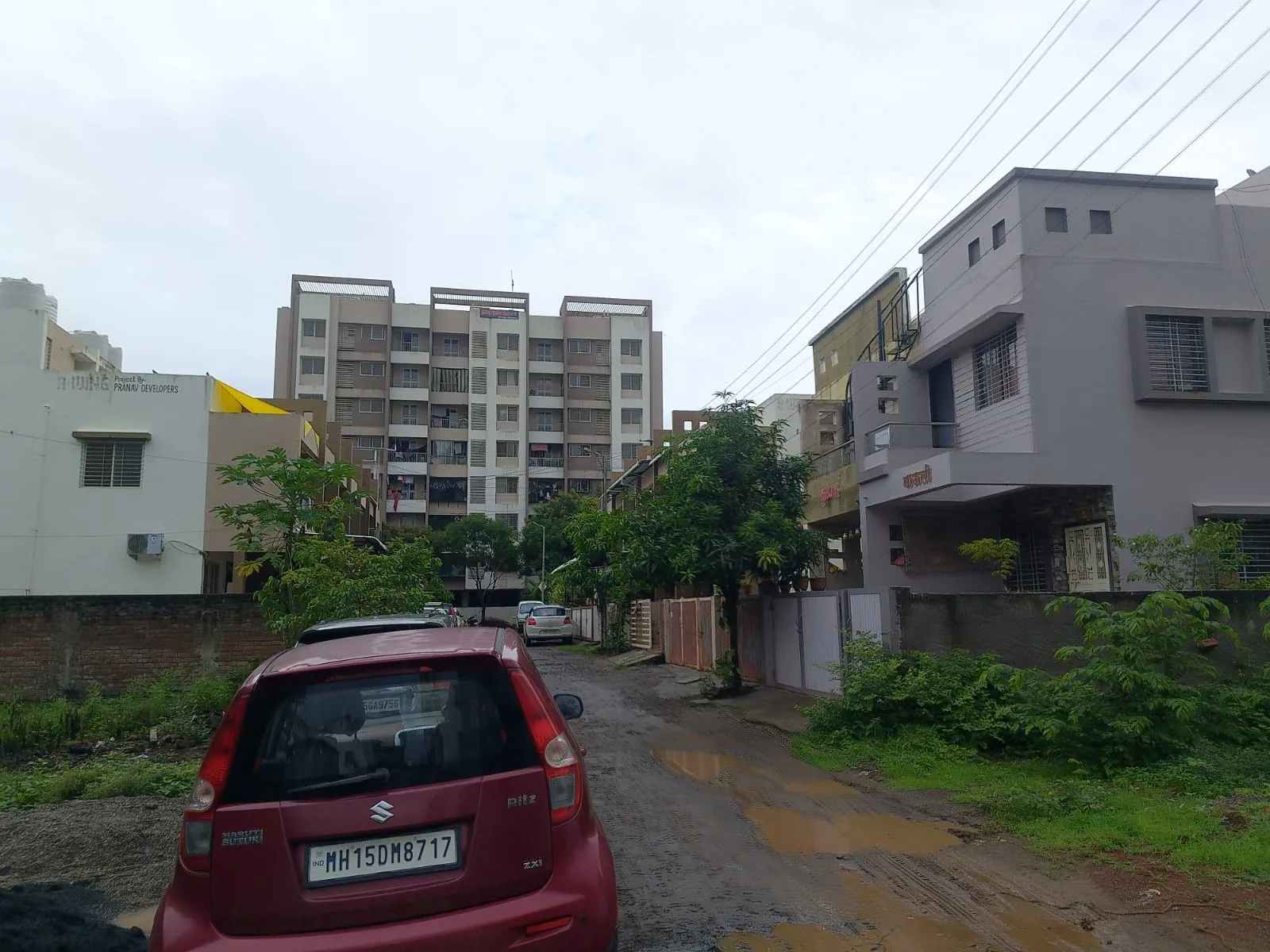 Established residential street in Adgaon, Nashik, near Plot No. 33, Gut No. 552 — apartments and bungalows